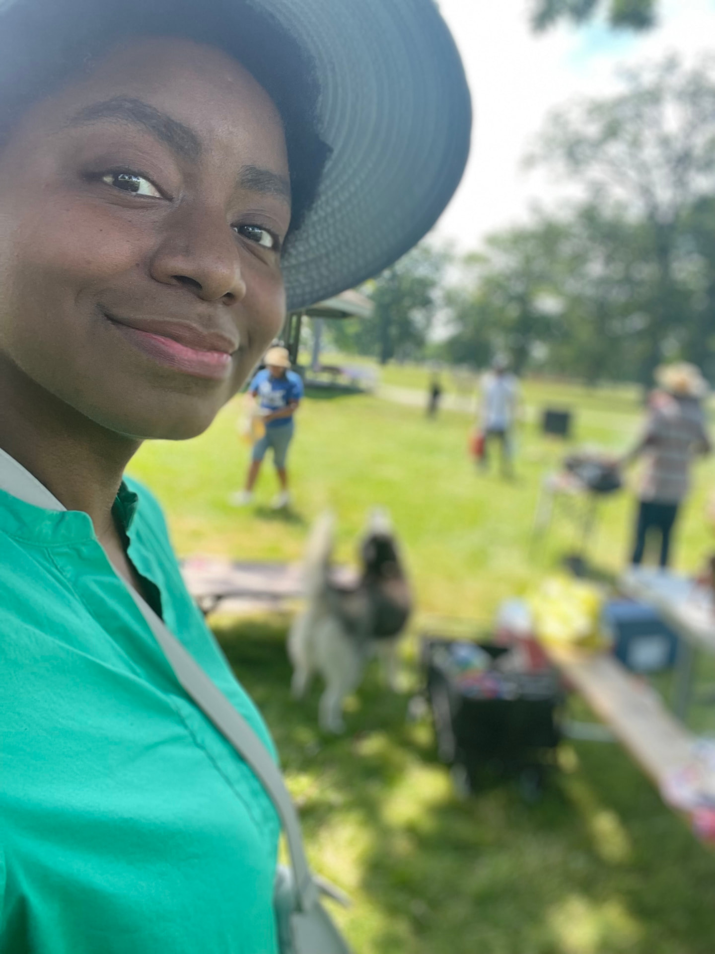 Laura outdoors in a park on a bright day
